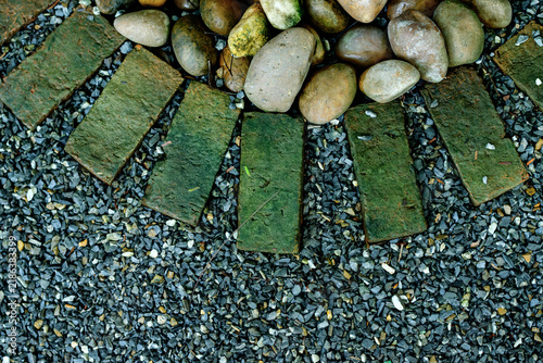 Sticker Overhead view of mossy green brick pavers arranged in a curved border alongside