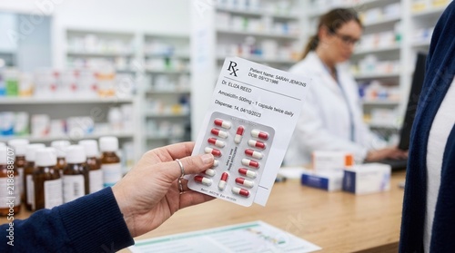 Patient Receiving Medication Prescription From Pharmacist In Pharmacy