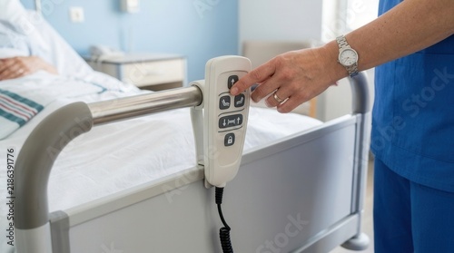 Nurse Adjusting Patient Bed Control Panel With Care And Precision