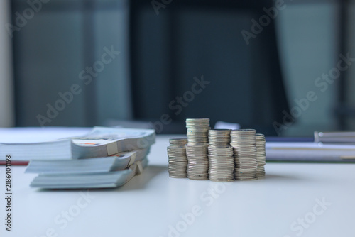 Принти на полотні Stacks of varying coin heights and bundles of neatly organized paper banknotes on office table