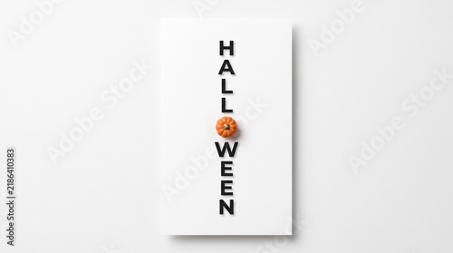 Vertical Halloween typography with a small orange pumpkin icon on a clean white background