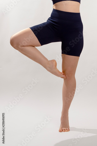 Person in Ballet Pose Exercising on Neutral Background
