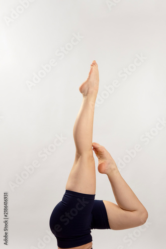 Person Stretching Legs in Yoga Pose on White Background