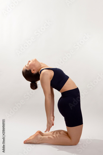 Woman Performing Camel Yoga Pose in Studio