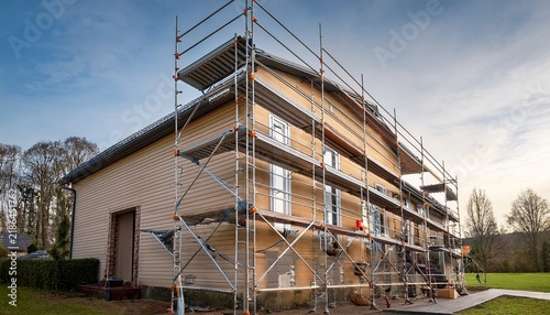 house exterior undergoing renovation painting scaffolding