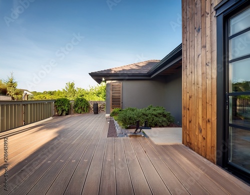 modern home backyard with composite deck and railing