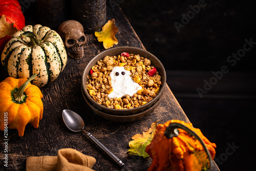 Halloween spooky breakfast with granola and yogurt in shape of ghost