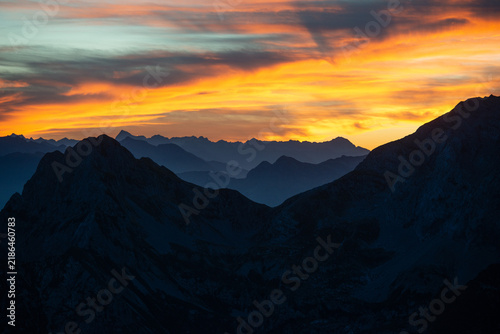 Mountain peaks at sunset with a fiery sky