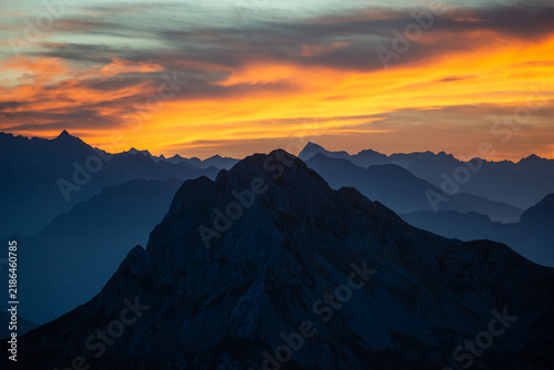 Mountain peaks at sunset with a fiery sky