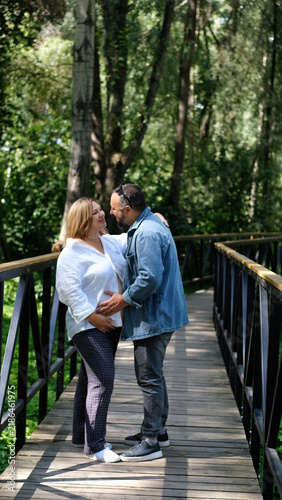Картината върху платно Expectant Couple Together in the Park, Pregnant Woman and Partner, Family Love,