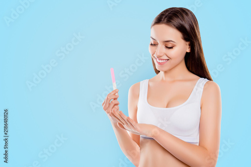 фотографія Portrait with copyspace of attractive pretty woman doing manicure looking at fin