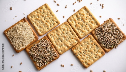 square crackers arranged with grains against a white background