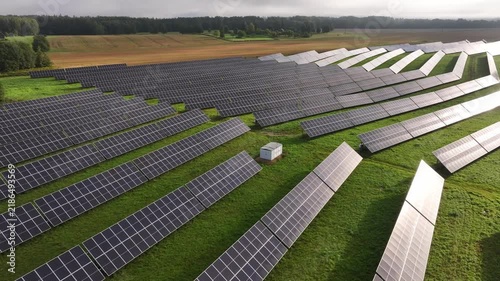 Aerial Drone View of Solar Farm With Sunlight Reflecting on Panels in Latvia