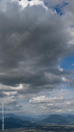 Dramatic Cloudscape Over Chilliwack, British Columbia's Fraser Valley with Moving Clouds and Majestic Mountains