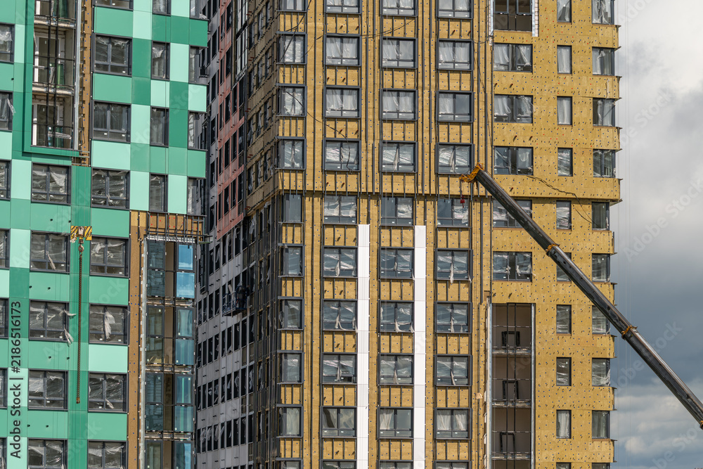 Fototapeta premium Construction of modern high-rise buildings in an urban setting showcases innovative design and emerging architecture