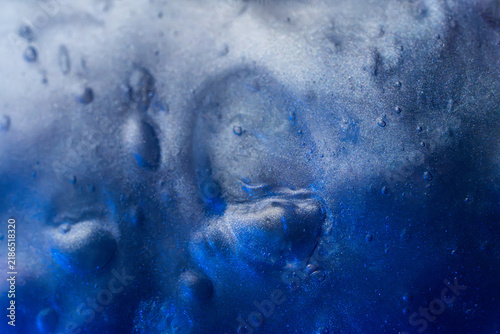 Abstract blue ice texture with frozen air bubble