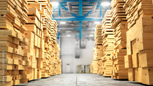 Large stacks of wooden lumber and timber boards stored inside a modern warehouse. Industrial storage facility with organized wood materials, construction supplies and natural timber textures. 
