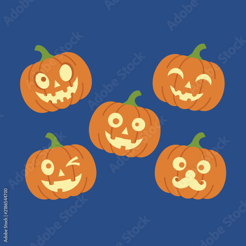 Five carved halloween pumpkins with funny jack o lantern faces isolated on a dark blue background.