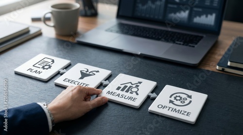 Businessman hand placing measure block in strategic plan execute measure optimize process, reflecting business performance improvement and workflow efficiency