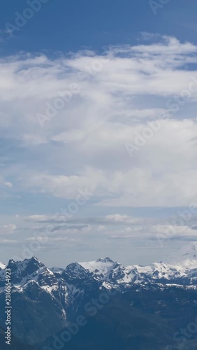 Majestic Snow-Capped Mountain Range Under a Vast Blue Sky in British Columbia, Canada