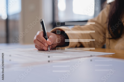 Close up young businesswoman hands writing pen on paper. hands writing planing meeting agenda on wooden table. Close up hand write using pen note Personal Organizer sign contrac