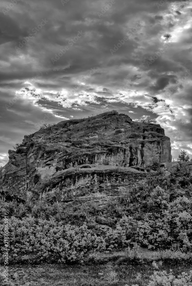Fototapeta premium Black and White Rock Formation Under Dramatic Sky