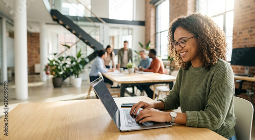 Confident female software developper smiling while working 