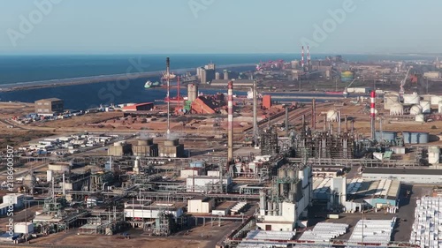 Aerial view of industrial pipes and equipment at an oil refinery plant. Heavy manufacturing infrastructure for petroleum production. 	