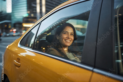 Happy Passenger Looking Through Taxi Window in Modern City