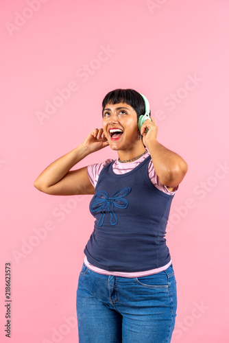 Young woman enjoying music with headphones, laughing