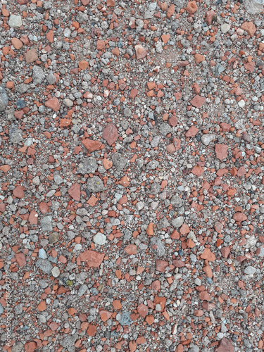 Photographic Red Brick and Grey Gravel Texture Background. Close-up of multicolored stones. Vertical photo.