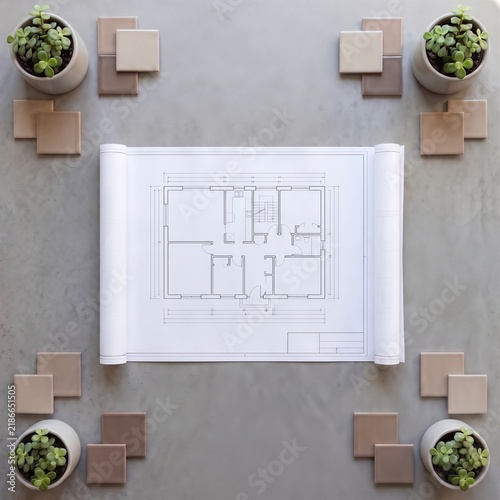 Top view of an architectural floor plan with neutral color ceramic tiles and succulent plants on a grey concrete background, interior design layout and home renovation planning