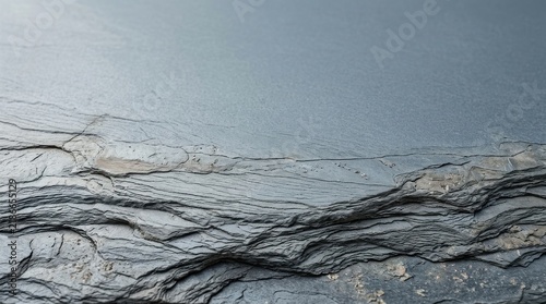Rough dark gray slate rock surface with sharp natural layers and sedimentary textures for organic architectural and design backdrops
