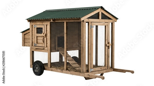 Wooden chicken coop tractor on wheels for backyard farming.