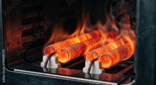 Close-up of glowing red-hot electric heating coils inside a space heater with visible heat waves