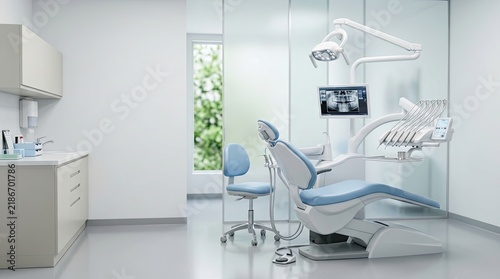 A dentist's office interior features a modern dental chair, an overhead light, and a digital X-ray system. A dentist is seated in the chair, preparing for an examination.