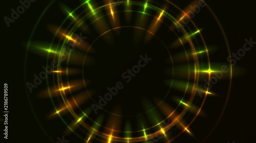 Green and orange neon laser rings with glowing rays on dark abstract background. Circular light effects create a futuristic focal element. Seamless loop. Video animation Ultra HD 4K 3840x2160