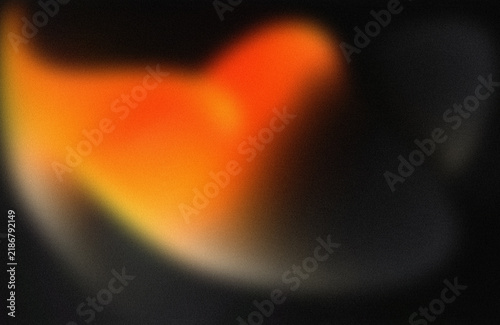 Quadro su tela Blurry orange abstract glow shape on dark
