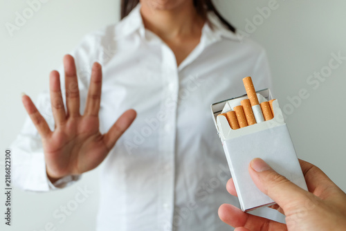Canvas Print A person making a stop gesture to refuse a pack of cigarettes being offered, representing quitting smoking, health awareness, addiction recovery, and willpower