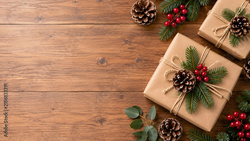Rustic Christmas Gifts with Pinecones and Evergreen Branches on Wooden Background