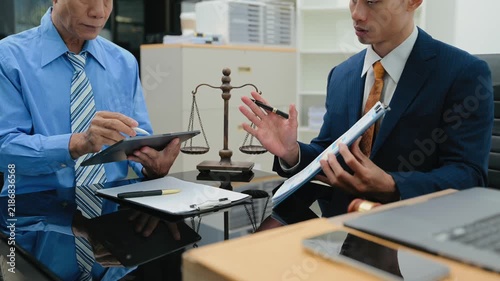 business people and lawyers discussing contract papers sitting at the table. Concepts of law, advice, legal services.