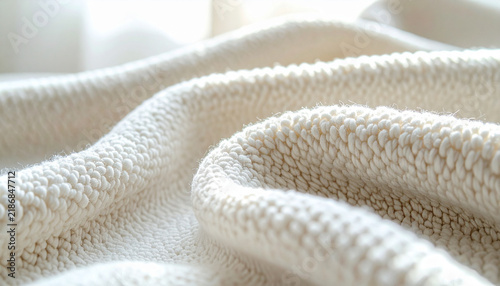 Pale boucle upholstery fabric with dense looped nubs curving gently under soft window light in creamy warm tones generative AI