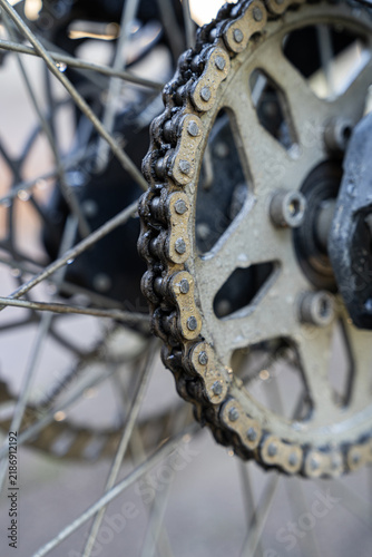 Close-up of dirty motorbike chain and rear sprocket