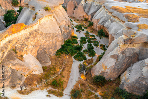 Obraz na plátně Narrow hiking trail winding through eroded volcanic rocks in Cappadocia