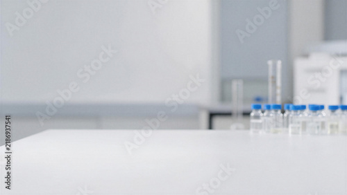 Empty white table top in blurred modern medical laboratory or scientific research center interior background