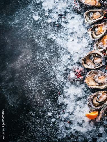 flat lay of oysters on a dark background, focusing on contrast, form, and modern food photography style. The image suits premium branding, menus, and editorial design. oysters,flatlay,minimal,dark,bac