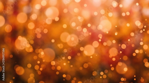 Warm golden bokeh background with soft light flares and blurred circles creating a festive atmosphere