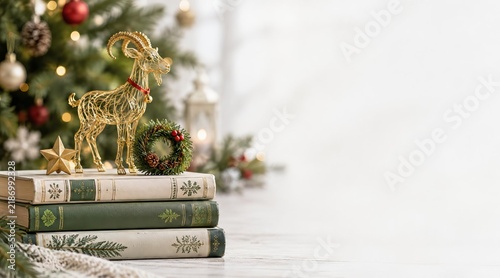 A stack of books with wire sculpture of a goat (the zodiac animal for 2027)