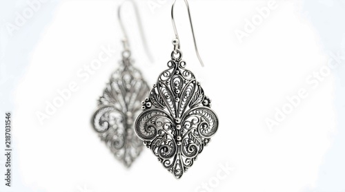 Elegant silver filigree dangle earrings with intricate metal scrollwork