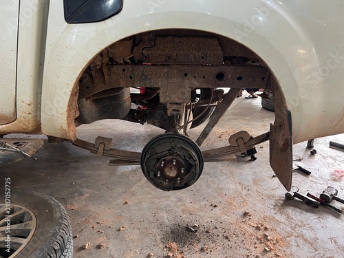 Obraz na płótnie Close-up of a car's brake system with wheel removed, showing hub, drum brake, and suspension components